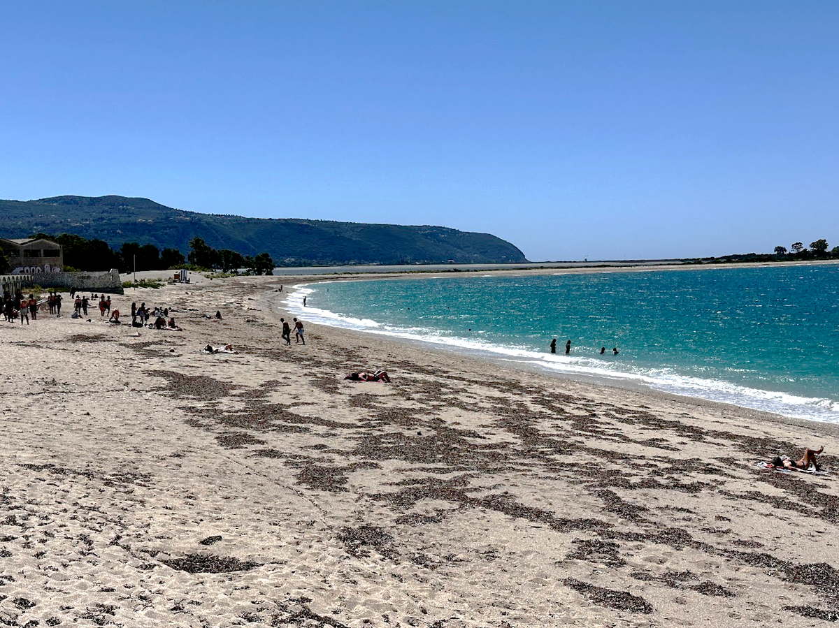 People enjoying sun-soaked days and calm seas at Kastro, Lefkada’s hidden gem