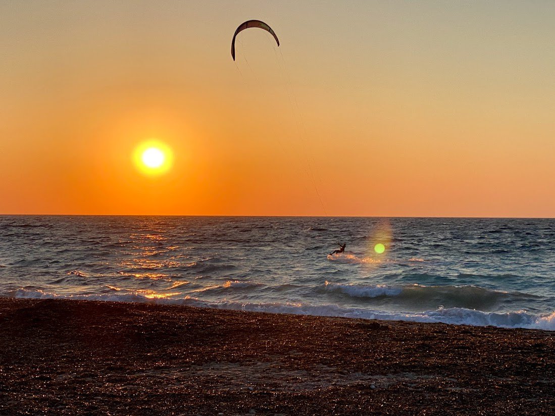 Sunset at Orlof’s Mill and kitesurfers at center stage @Andreas Thermos